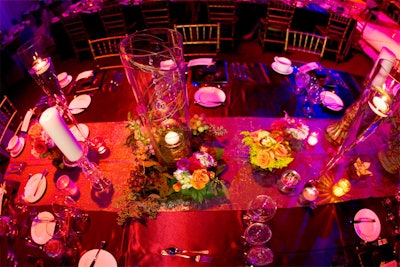 Candles and floral arrangements in various sizes, some with fruit, topped the dinner tables.