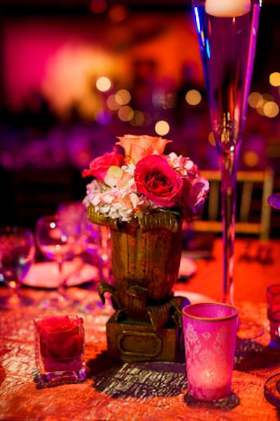 Various styles of antique gold containers housed the tabletop floral arrangements.