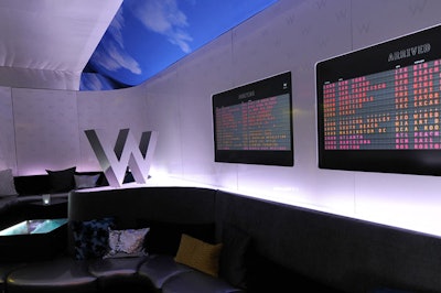 The backstage suite for W Hotels Worldwide was designed to highlight the brand's new and soon-to-open properties in London; Paris; St. Petersburg, Russia; Koh Samui, Thailand; and Bali, Indonesia. Seating was inspired by luggage conveyor belts, and displays styled after airport arrival and departure boards named the locations of the upcoming hotels.