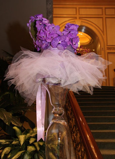 Ballerina costumes made of purple flowers and lace framed the stairs leading up to the ballroom.