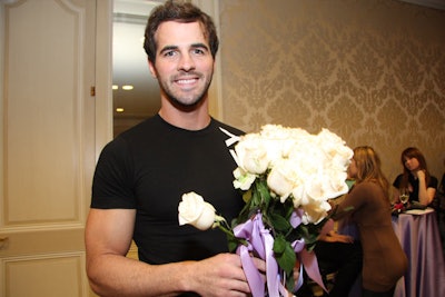 During the cocktail reception, male models passed out long-stem roses tied with lavender ribbons.