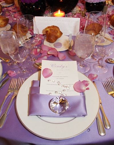Diamonds, rose petals, and purple linens decorated the tables, which were preset with popovers and rounds of rosemary-flavored purple butter.