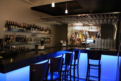 An eight-seat bar is tucked into one corner of the ground-floor dining room.