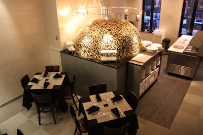 The restaurant's wood-burning pizza oven is the centerpiece of the main dining room.
