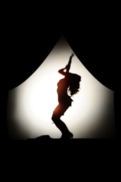 A burlesque dancer performed a shadow show in a small room adjacent to the upside-down lounge.