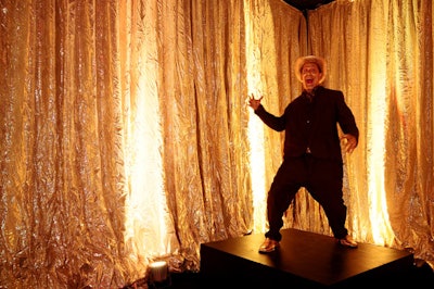 A gold-painted cowboy danced on a platform in a gold-draped room just off the upside-down lounge area.