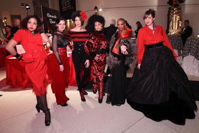 Opera supernumeraries wandered the event space in black and red costumes that evoked French couture.