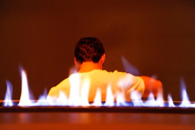 The fire strip at the bar and the glass-enclosed fireplaces scattered around the raw space created a warm atmosphere.