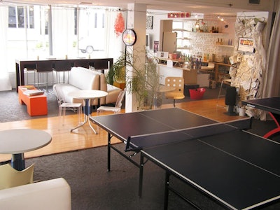 The entryway divides the space into a lounge and cafe space and recreation area with ping-pong tables.
