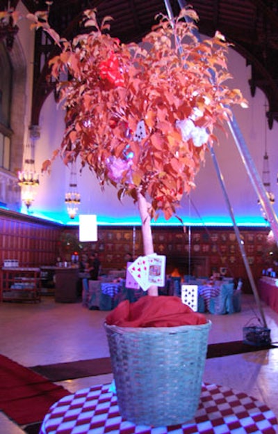 Oversize playing cards hung from potted plants.