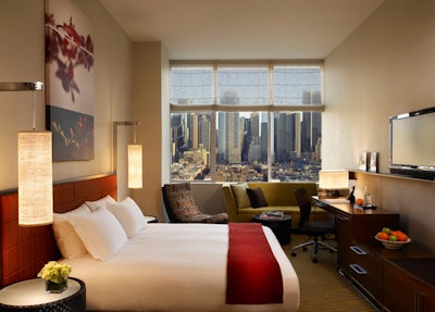 Each of the guest rooms is accented with abstract artwork, colorful furnishings, and stone-tiled bathrooms.