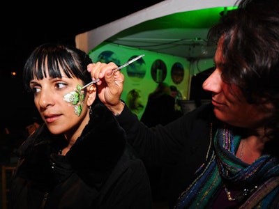 Artists provided free face painting at a table outside the BubbleQ main tent.
