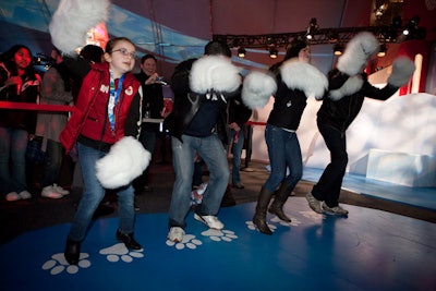 One of the games in the Coca-Cola pavilion required guests to don giant polar bear paw gloves.