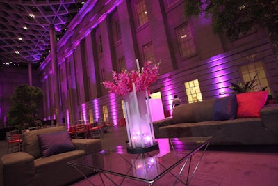 A Vista provided frosted LED vases, which housed pink makara orchid arrangements by Just Outrageous Events.