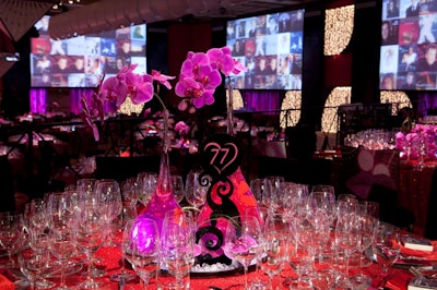 Red cloths and purple orchids topped tables.