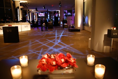 Votive candles and small floral arrangements punctuated the few tables, pushed to the sides of the lobby to accommodate the capacity crowd.