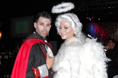 Models dressed in vampire and angel costumes handed out plastic fangs and halo headbands to guests.