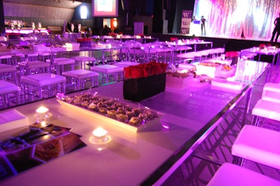 Black vases filled with red roses, from Designing Trendz, topped tables at the Kool Haus.