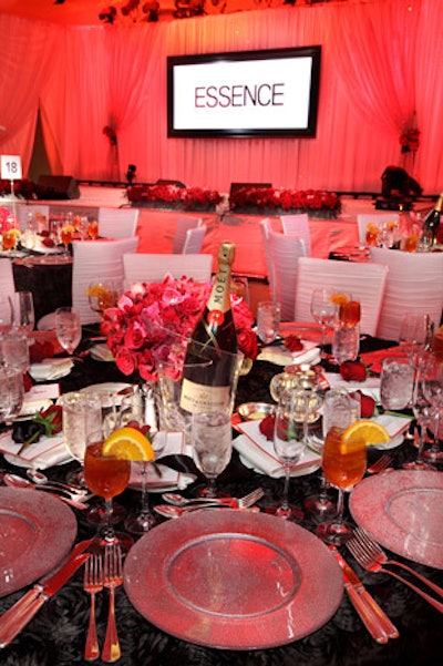 Red roses and black linens in a rosette motif topped tables.