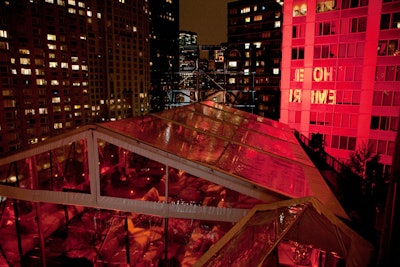 Erected on the east terrace, a custom clear-span structure provided additional space for guests and mimicked the Brooklyn Bridge's truss and cables with gobo projections and black framework.