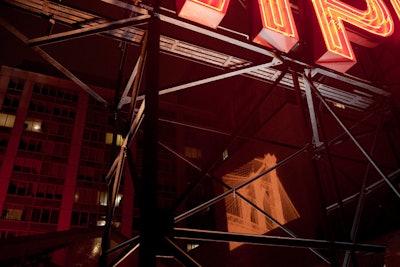 Behind the hotel's sign and above the tent, the design team projected images of the Brooklyn Bridge.