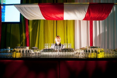 A striped awning gave the bar in the school gym—manned by a bartender clad in a referee uniform—a sporty look.