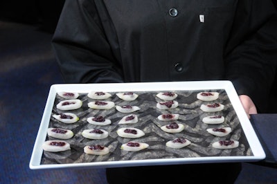 Servers passed black olive tapenade in white icicle radish boats during the cocktail hour.