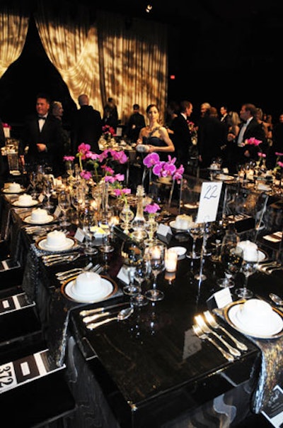 Silver and black damask linens and hot pink orchids topped the dinner's rectangular tables.