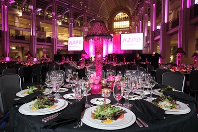 Giant screens displayed the gala's logo, designed by Betsey Johnson. To ensure that all guests could experience the program, one screen was devoted to closed captions for the evening's remarks, and a sign language interpreter was also present.