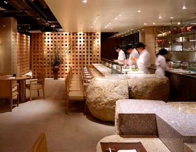 Zuma restaurant in the Epic Hotel will have a similar look to the chain's original London restaurant (pictured) with natural wood furniture and stone accents.