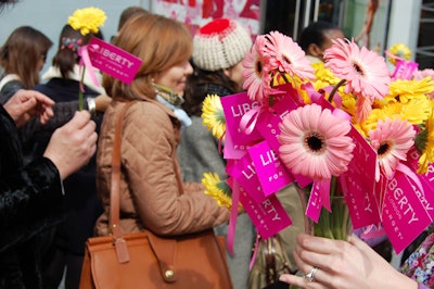 Target staffers handed out flowers to shoppers waiting outside the store on Wednesday. Security kept the crowds under control by admitting only a handful of customers at a time.