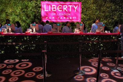 Leafy foliage and a hedge wall marked the cash register area.