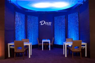 Four stations for hand massages were set up in a small alcove with tranquil blue lighting.