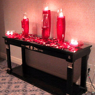 For the cocktail reception preceding the Magazine Publishers of America's Henry Johnson Fisher awards dinner, Floralia decorated the hall leading to the Waldorf=Astoria's Starlight Roof with candles floating in large vases filled with red liquid.