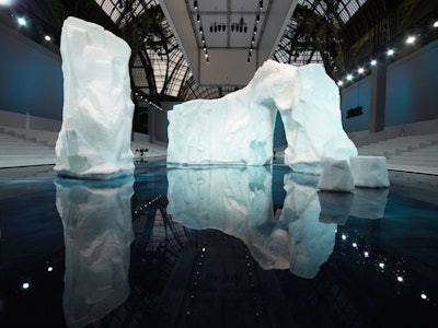 Under the directives of Lagerfeld and his in-house creative team, Villa Eugenie flew in 35 ice sculptors, who spent six days creating an iceberg from 240 tons of frozen snow ice transported from Sweden.