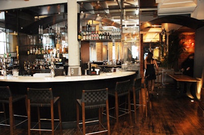 A steel and glass bar divides the café from the dining room.