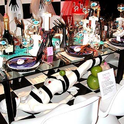 A trashy but chic table sponsored by Tiffany Dubin for Lair used the most props, including a reclining mannequin under the glass table and wine glasses painted with blue eyes.
