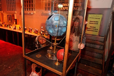 Performers roamed through the party with a machine that housed spinning planets and miniature ships.