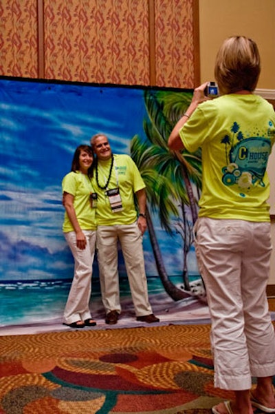 The National Association of College Stores Foundation provided a tropical photo backdrop; souvenir pictures had to be picked up at the foundation's booth at the convention center.