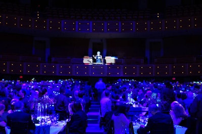 After guests sat for dinner, a bank representative welcomed them from the balcony opposite the stage.