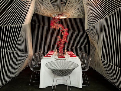 Architect Arpad Baksa was one of the only designers to incorporate a message about AIDS in a dining space. Baksa's woven rope installation, which covered the room, symbolized how people are all connected. A black, white, and red palette added to the effect.