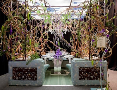 David Beahm's table for Continental Airlines did not go for a branded look. Instead, the designer created a space reminiscent of a secret garden, complete with twisted vines, cascading tulips and orchids, and a large chandelier.