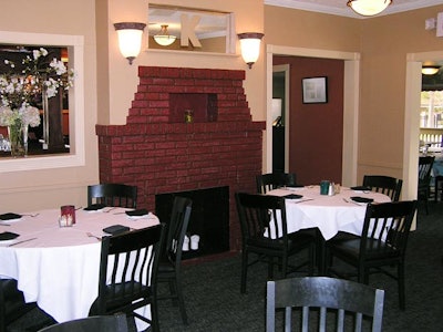 The Fireplace room, a semiprivate space created when the main dining room is separated with curtains, seats 20.