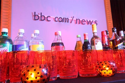 Bartenders served drinks in bright orange tumblers to match the decor.