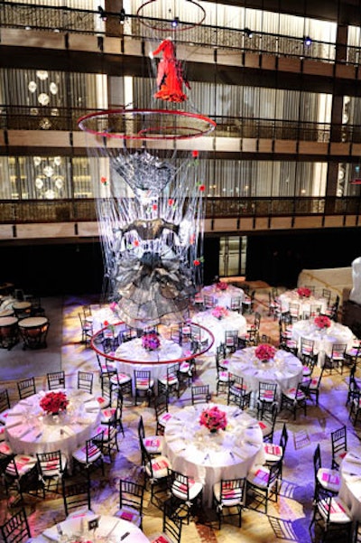 Making use of the David H. Koch Theater's promenade, the setup for the dinner included a large dance floor and dinner tables below E.V. Day's installation of vintage costumes from the New York City Opera.