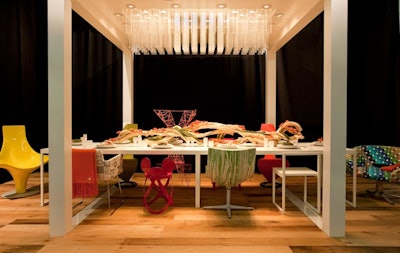 Chairs of different shapes, colors, and styles from Disney's furniture line surrounded the company's table.