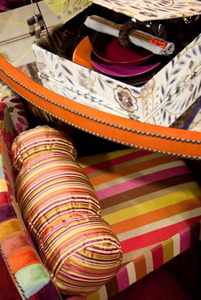 Kravet mixed bright florals and stripes on dining chairs and Japanese-style fabric-covered boxes at each place setting.