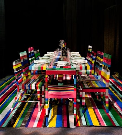 Slade Architecture collected discarded furniture from the streets of New York, including a range of dining chairs, and covered the pieces in colored masking tape, creating a bold striped look.
