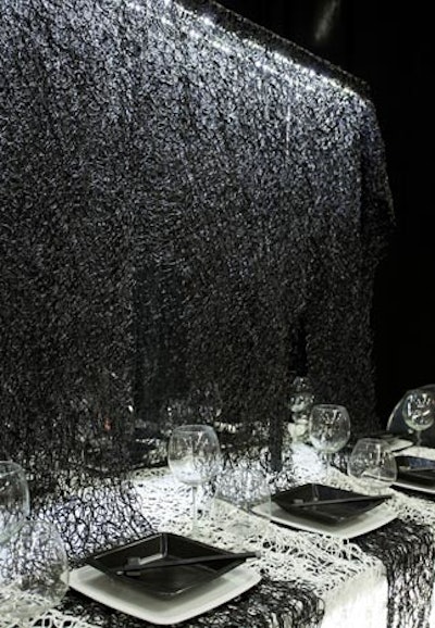 Razortoothdesign's black and white dining space was also divided by a curtain made of a foamy netted material. The fabric was cut and draped to create a place mat for each place setting.