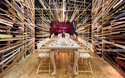 Michael Tavano worked with students from the New York School of Interior Design to create a dramatic space with a neutral table setting and walls covered in strips of wood.